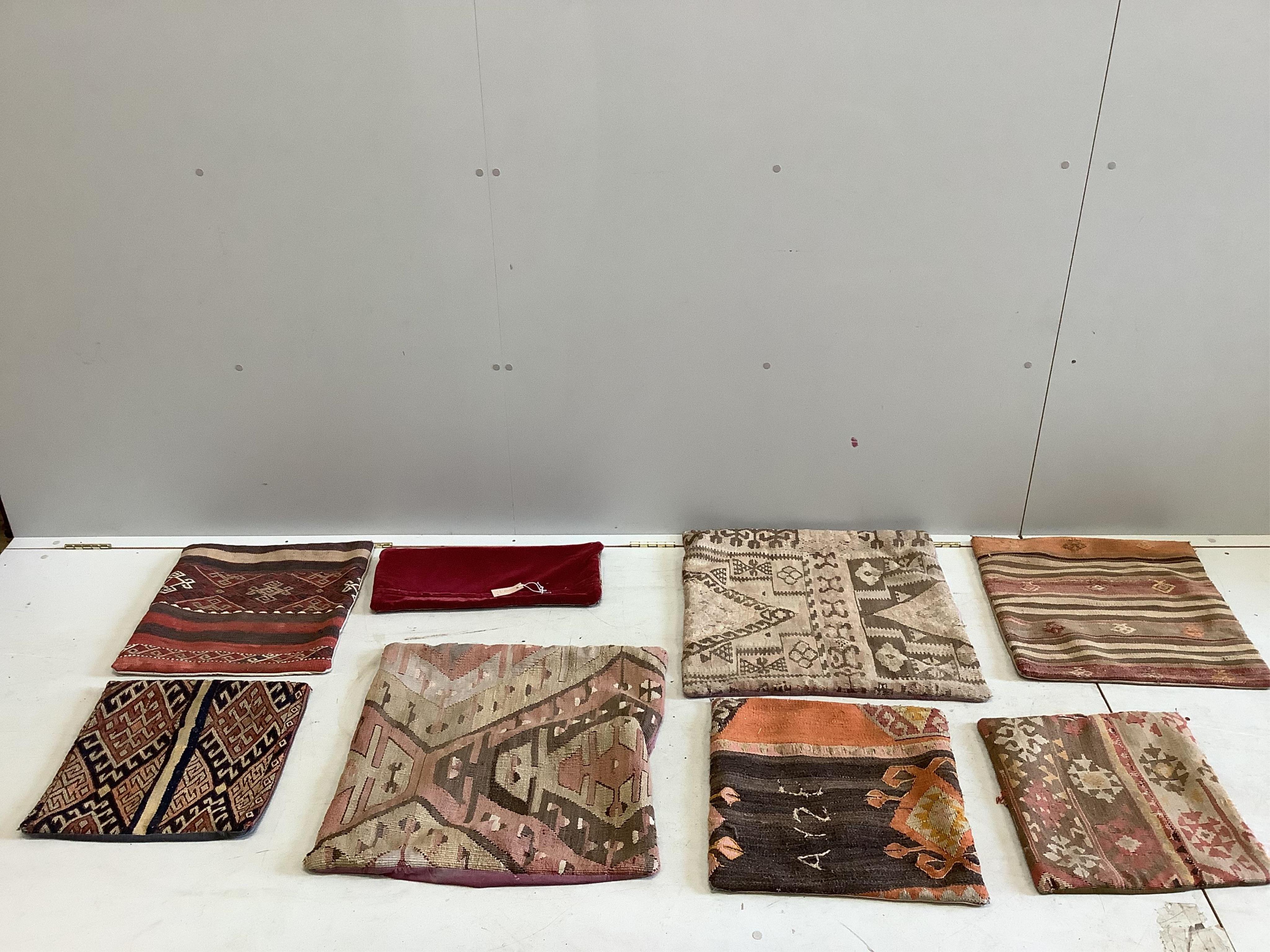 Seven assorted Kilim rugs, mats and cushion covers, largest 60 x 57cm. Condition - mostly faded, some wear